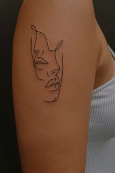 a woman's arm with a line drawing of a face on it