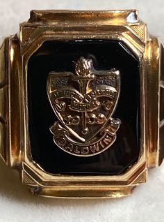 "A very vintage 10K yellow gold class ring for your consideration.  This bold ring is hallmarked 10k and guaranteed to be such. The maker's mark is also present and looks to be \"Deges &Clust\" The ring is from Baldwin College or School and dates back to 1909 according to the crest. I can't find creation dates to match. The black onyx center stone hold the crest of the school and heralds it's name.  The traditional graduation date of 1945 adorns the sides. The center stone measures approximately 12mm x 9.5mm.  The ring measures 16.7mm at its widest and tapers to 3.2mm in the back. It is a size 9 1/2 and weighs in at 6.7 grams. It's a great piece of history!" Classic Signet Ring For Commemoration, Classic Hallmarked Signet Ring For Commemoration, Classic Engraved Ring With Hallmarks, Classic 14k Stamped Signet Ring For Commemoration, Antique Gold Signet Ring For Commemoration, Classic Hallmarked Engraved Ring For Commemoration, Gold Antique Signet Ring For Commemoration, Collectible Art Deco Signet Ring With Polished Finish, 14k Gold Heirloom Signet Ring For Commemoration