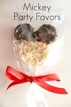 two heart shaped cookies wrapped in plastic wrapper with red ribbon on top and text that reads mickey party favors