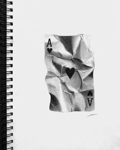 a spiral notebook with playing cards drawn on the cover and in black and white paper