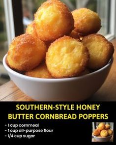 a bowl filled with butter cornbread poppers on top of a wooden table