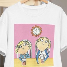 Charlie and Lola t-shirt for fans of the series! Wake up the nostalgia with this adorable Charlie and Lola t-shirt. Ideal for fans of all ages. Do you remember the adventures of Charlie and Lola? This t-shirt will transport you to his world full of imagination and fun. Perfect for: -- Fans of the series: An ideal gift for any Charlie and Lola fan. -- Boys and girls: A comfortable and fun garment for the little ones. -- Special occasions: Birthdays, theme parties or just for a casual day. -- Outfit Complement: Pair it with jeans, shorts or a skirt for a casual and adorable look. 🩳 Show your love for Charlie and Lola with this amazing t-shirt! **Shipping Information - Orders are processed within 1-3 business days. - Estimated delivery time is 5-20 business days depending on your location. Cotton T-shirt With Cartoon Print For Fans, Retro Cartoon Print T-shirt For Fans, 90s Style Character Print T-shirt, 90s Character Print Short Sleeve T-shirt, 90s Short Sleeve T-shirt With Character Print, White 90s T-shirt With Character Print, White T-shirt With Cartoon Print For Fan Conventions, Short Sleeve T-shirt With Cartoon Print For Fans, White Cartoon Print T-shirt For Fans