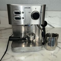 a silver coffee maker sitting on top of a counter