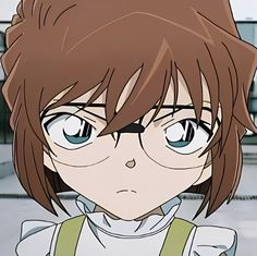 an anime character with glasses and brown hair looks at the camera while standing in front of a building