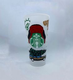 a starbucks cup with a red hat on it