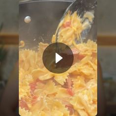 a person is pouring some food into a pot with water in it and the video appears to be blurry