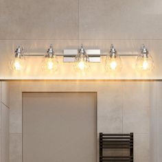 a bathroom vanity light with five bulbs on it