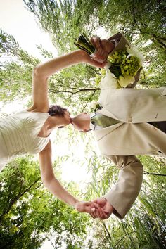 the bride and groom are holding their hands together