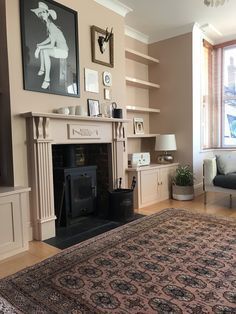 a living room filled with furniture and a fire place