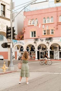 a woman crossing the street at an intersection