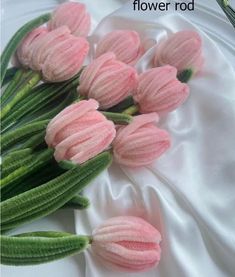 pink tulips with green stems on a white satin background that says flower rod