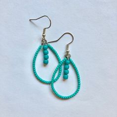 These handmade, beaded teardrop shaped earrings come in a variety of colors. this pair is A teal turquoise color. Perfect for all occasions and super comfortable to wear. These earrings are not heavy at all and can be worn comfortably all day. The earrings are 2 cm across. Every pair is unique and  may look somewhat different than the picture. I love making these earrings and hope you enjoy wearing them! Adjustable Beaded Turquoise Teardrop Earrings, Green Teardrop Earrings With Tiny Beads, Green Teardrop Beaded Earrings With Tiny Beads, Bohemian Turquoise Teardrop Drop Earrings, Turquoise Teardrop Beaded Earrings As Gift, Turquoise Bohemian Teardrop Earrings, Turquoise Teardrop Beaded Earrings For Gifts, Colorful Beads Teardrop Earrings, Bohemian Turquoise Beaded Teardrop Earrings