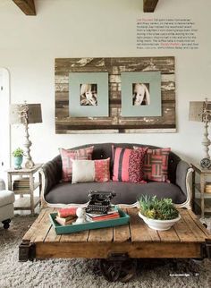 a living room filled with furniture and pictures hanging on the wall above it's coffee table