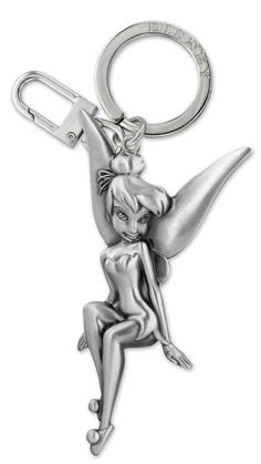 a metal keychain with a woman sitting on it's back and holding onto the