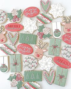 decorated christmas cookies are arranged on a white surface