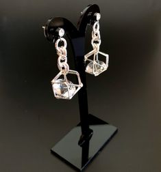 Unusual, sparkly diamond shaped crystals are captured in silver plated cages. I have joined them to the crystal, non allergenic, stainless steel posts with chain maille. Nice neutral earrings will go with anything. Makes a lovely gift. Here is a link to my whole shop: https://www.etsy.com/shop/designsbymalone RETURNS - BUY WITH CONFIDENCE Don't worry, I will refund or exchange an item up to 60 days. Makes gift giving easy! All my items will arrive in a gift box and/or a velvet or organza pouch. Single Crystal Earring As A Gift, Clear Crystal Earrings As A Gift, Clear Crystal Earrings For Gift, Nickel-free Crystal Earrings For Formal Occasions, Party Earrings With Clear Metal, Formal Nickel-free Crystal Earrings, Crystal Drop Clip-on Earrings For Gifts, Faceted Crystal Party Earrings, Modern Silver Crystal Earrings