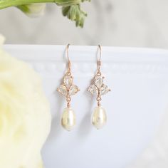 Sophisticated and elegant, The Rose Earrings in Rose Gold, are the perfect complement to summer weddings. Dress your bridesmaids in simple glamour with earrings that can be worn long after your wedding day. Size: 1.5" long Materials: cubic zirconia, Swarovski pearls in white Metals: rose gold filled ear wires and components, rose gold plated links Find the matching necklace here Elegant Rose Design Earrings For Wedding, Elegant Rose Design Wedding Earrings, Classic Rose Gold Bridal Earrings For Wedding, Delicate Rose Gold Crystal Earrings For Wedding, Elegant Rose Design Drop Earrings, Elegant Rose Gold Bridesmaid Earrings, Dangle Earrings With Rose Design For Wedding, Rose Gold Rose Design Wedding Earrings, Xo Necklace