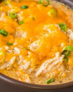 a crock pot filled with chicken, cheese and green peppers on top of it