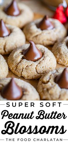 chocolate chip cookies with peanut butter on top and the words, super soft peanut butter blossoms