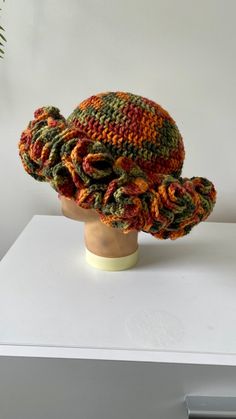 a crocheted hat on top of a white mannequin head