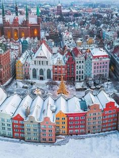 an aerial view of a city with many buildings and a christmas tree in the center