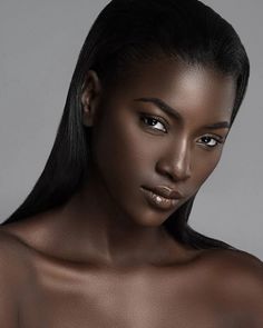 a woman with long black hair is posing for the camera