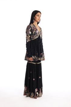 Kinfolk Black applique embellished mulberry crepe kurta, gharara with organza dupatta. From Aisha Rao's Kinfolk collection. DELIVERY TIMEPlease allow 6-8 weeks for your outfit to arrive. FABRIC DETAILSMulberry Crepe Professional cleaning only. Black Embellished Palazzo Set For Eid, Black Embellished Palazzo Set For Diwali, Traditional Embellished Black Palazzo Set, Designer Embellished Black Palazzo Set, Black Long Sleeve Anarkali Set With Mirror Work, Embellished Black Bollywood Palazzo Set, Embellished Black Sharara For Eid, Bohemian Designer Wear Sharara In Georgette, Bohemian Georgette Sharara For Designer Wear