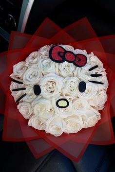 a bouquet of roses with hello kitty on it