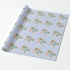 a blue wrapping paper with flowers and leaves on the top, in pastel colors