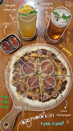 a pizza sitting on top of a wooden table next to two glasses filled with drinks