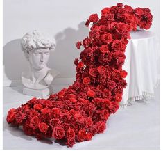 there is a sculpture made out of red roses