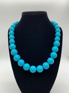 Turquoise colored beaded necklace of varying sized beads. A fun piece to add a pop of color to your work or casual outfit! Necklace is 29 inches with a 3 inch extender Turquoise Necklace With Large Beads, Turquoise Necklace With Large Round Beads, Turquoise Beaded Necklaces With Round Beads, Blue Turquoise Necklace With Colorful Beads, Blue Turquoise Necklace With Colorful Round Beads, Turquoise Beaded Necklaces With 8mm Beads, Turquoise Beaded Necklace With 8mm Beads, Turquoise Large Beads, Adjustable Turquoise Necklace With 8mm Beads