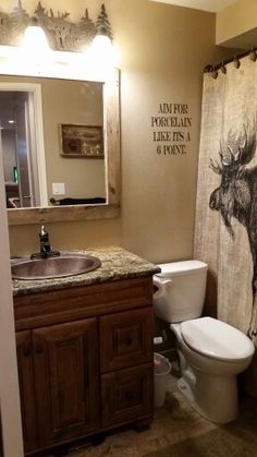 this bathroom has a shower curtain with an image of a moose on it and the words am pmr perplexix like its a ponies