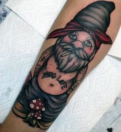 a man's arm with a gnome tattoo on it