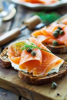 two slices of bread topped with salmon and capers