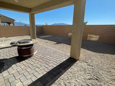 an empty patio with a barrel on the ground