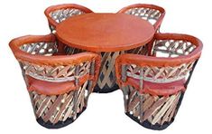 four chairs and a table made out of woven material