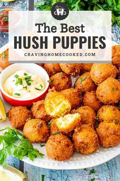 the best hush puppies recipe on a plate with dipping sauce and lemon wedges