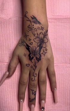 a woman's hand with tattoos on it