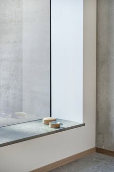 a bowl sitting on top of a counter next to a glass window in a room