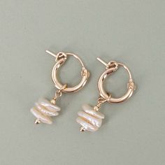 PLEASE BE AWARE.  ORDERS PLACED FROM JULY 16-23, WILL SHIP BEGINNING JULY 24, IN THE ORDER RECEIVED.These Keshi Pearl Earrings are the perfect blend of elegance and uniqueness, featuring mini or huggie hoop earrings with cornflake-shaped keshi pearl dangles. Designed to match our Keshi Pearl Necklace, they make a stunning set. Each pair of earrings comes in a complimentary gift box, making them an ideal gift. -Elegant Design: Mini or huggie hoop earrings with cornflake-shaped keshi pearl dangles 14k Gold-filled Pearl Drop Huggie Jewelry, 14k Gold Filled Pearl Drop Huggie Jewelry, White 14k Gold Filled Huggie Earrings, 14k Gold Huggie Hoop Earrings With Pearl Drop, 14k Gold-filled Huggie Earrings, Handmade Huggie Earrings For Anniversary, Elegant Adjustable Dangle Huggie Earrings, Small Hoop White Huggie Earrings In 14k Gold, Handmade 14k Gold Filled Drop Huggie Earrings