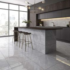 a modern kitchen with marble counter tops and bar stools