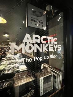 the front window of an artic monkey's pop up shop