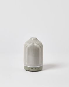 a white and grey ceramic object on a white background