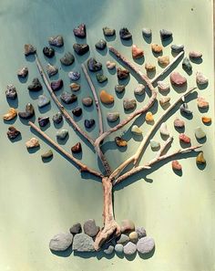 a tree made out of rocks sitting on top of a wall