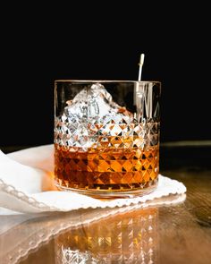 a glass filled with ice sitting on top of a table