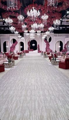 a large room with chandeliers, couches and flowers on the ceiling is shown