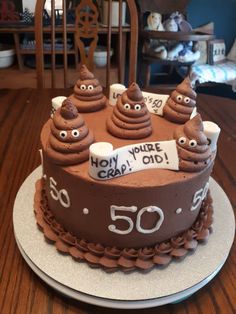 a birthday cake with chocolate frosting and googly eyes for someone's 50th