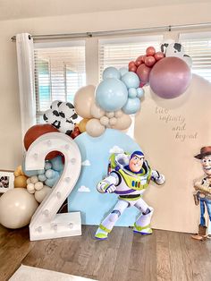 a room with balloons and decorations for a toy story birthday party, including buzz the spaceman