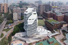 an aerial view of a large building in the middle of a city with lots of tall buildings